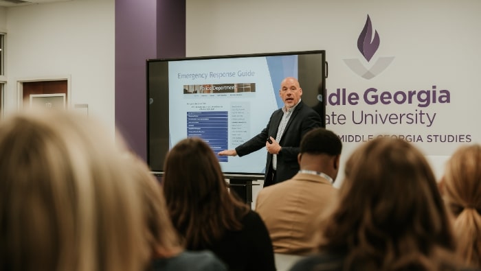 Chief Mitchell speaking to a seated audience about the Emergency Response Guide at the CMGS